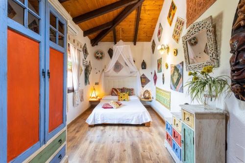 a bedroom with a bed in a room with wooden ceilings at Finca el Albero in Carratraca