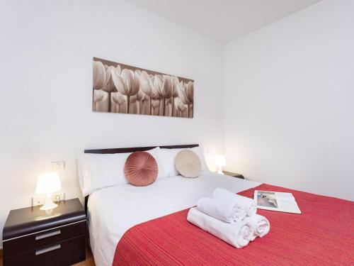 a bedroom with a bed with towels on a red blanket at Live puertito Fragata With balcony in Puertito de Güímar