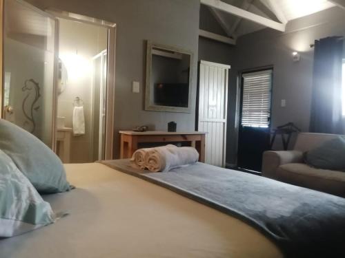 a dog laying on a bed in a bedroom at Seaforth Guesthouse in East London