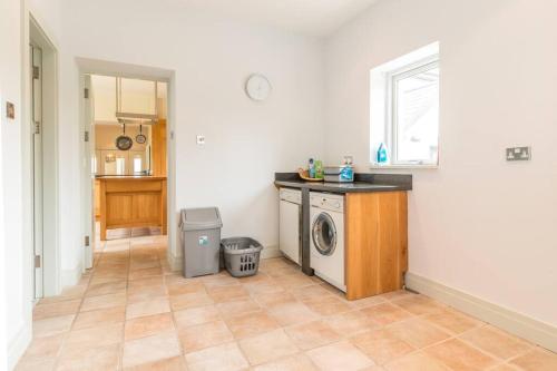 a kitchen with a washing machine in a room at Country Setting in the Middle of Dingle Town. in Dingle