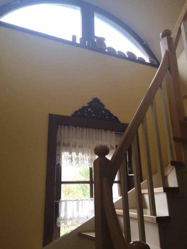 a stairway with a window and a stair case with a windowigunigunigun at Komfortowy dom w lesie in Miedzichowo