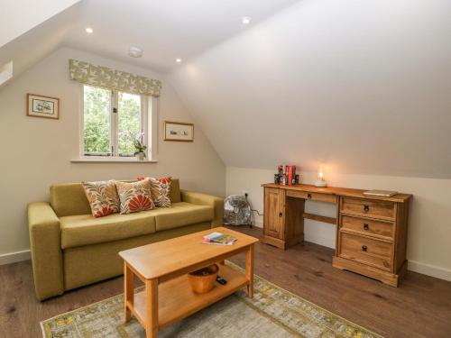 a living room with a couch and a table at The Attic at Redmond Bottom in Wells