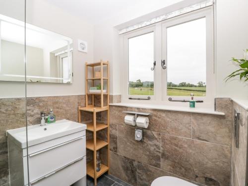 a bathroom with a sink and a window at The Attic at Redmond Bottom in Wells