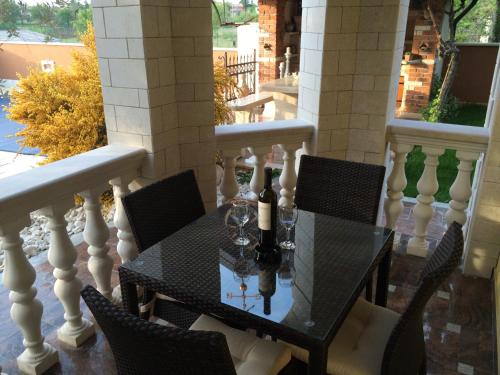 a table with two bottles of wine on a balcony at Apartments Barbara in Poreč