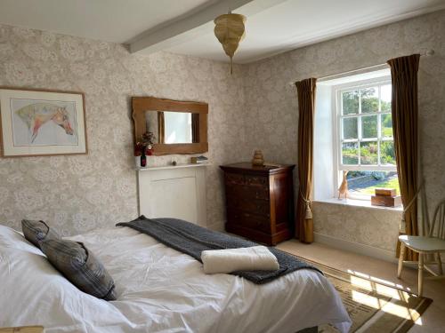 a bedroom with a large bed and a window at Stone House in Kington
