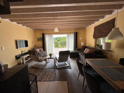 a living room with a couch and a table at Szarejkowe Wzgórza in Szarejki