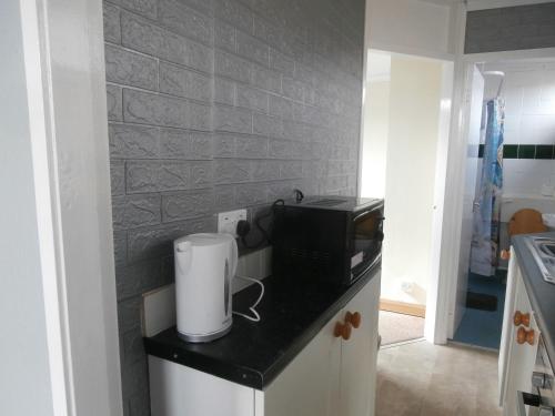 a kitchen with a counter with a microwave and a toaster at Inviting 2-Bed Chalet in Mablethorpe in Mablethorpe