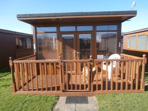 a screened in gazebo with a dog on it at Inviting 2-Bed Chalet in Mablethorpe in Mablethorpe