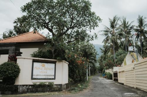 a street with a sign on the side of a building at ALOKA BAHARI Villas in Tejakula