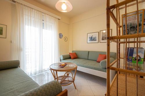 a living room with a couch and a table at Anastasia Sea View by RentalsPro Services - Nea Potidaia Halkidki in Nea Potidaea
