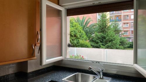 a kitchen sink and a window with a view at Family Apartment / Apartamento familiar Getxo in Getxo