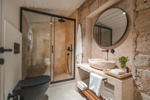 a bathroom with a shower and a toilet and a mirror at 6 ROOMS BY AZUMARE in Side