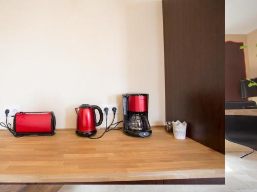 two coffeemakers sitting on a counter in a room at La Comédie de Pézenas - Appartements in Pézenas