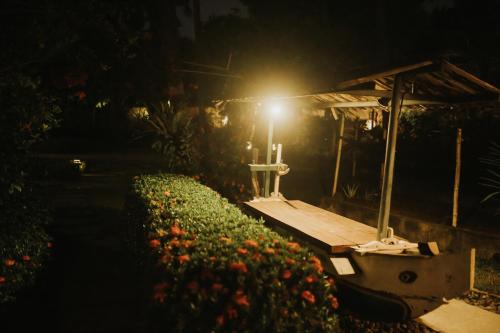 a light on a table in a garden at night at ALOKA BAHARI Villas in Tejakula