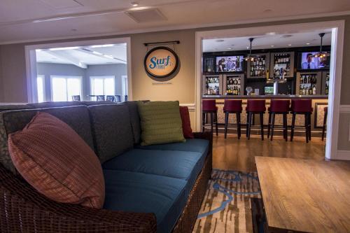 a living room with a couch and a bar at Cedar Point Hotel Breakers in Sandusky