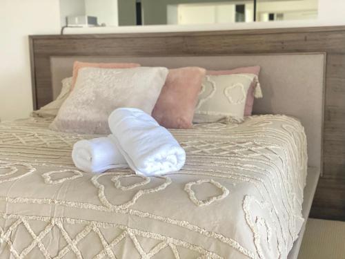 a bed with two pillows with hearts on it at Luxury house in heart of Hopeisland in Gold Coast