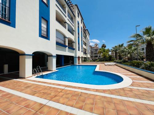 a swimming pool in front of a building at Marina 4 apartment in Huelva