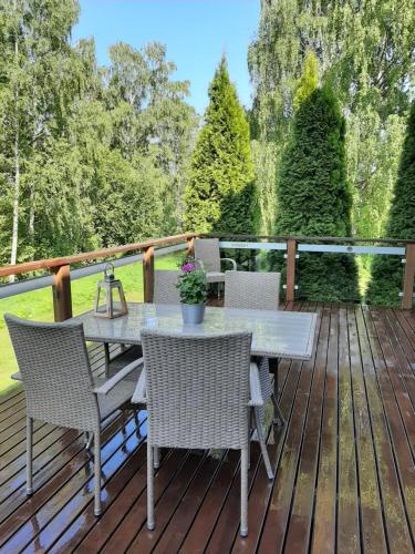a patio with a table and chairs on a deck at Kiurun Villas in Imatra