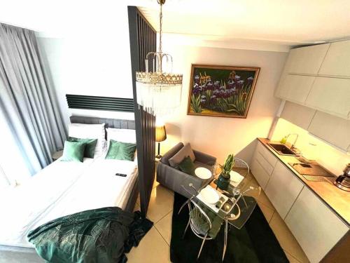 a small bedroom with a bed and a desk at Sea Promenade Luxury Apartment in Świnoujście