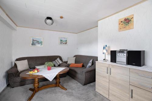 a living room with a couch and a table at An der Rehkoppel in Boren