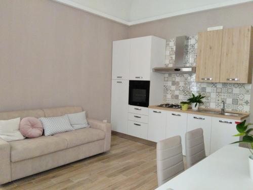 a living room with a couch and a kitchen at Abruzzo Holiday in Ortona