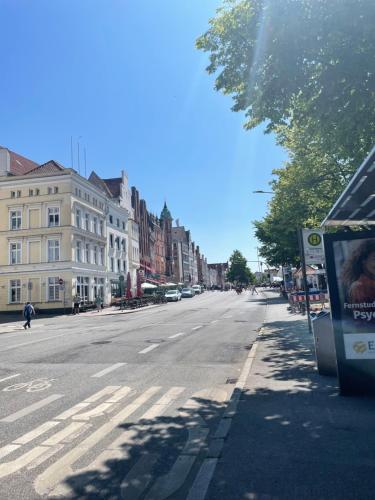 an empty street with buildings on the side of the road at Ferienwohnungen am Holstentor in Lübeck
