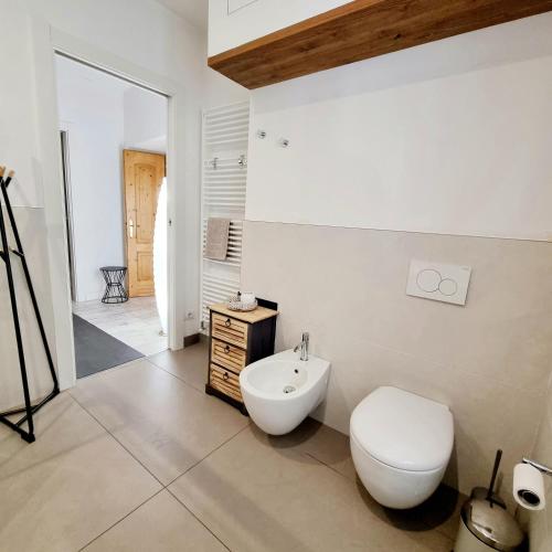 a white bathroom with a toilet and a sink at 1Dest - Living The Dream in Arco