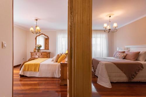 A bed or beds in a room at Casa Bértolo