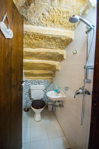 a bathroom with a toilet and a sink at The Burrow Guest House in Tarxien