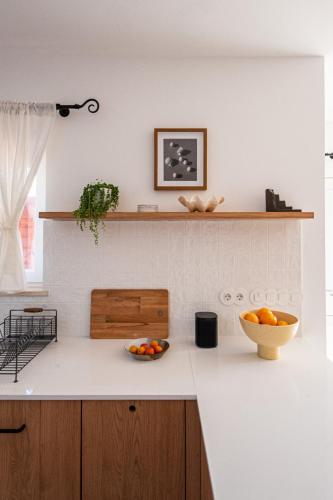 a kitchen with a bowl of oranges on a counter at Casa da Almargens in Bordeira
