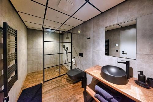 a bathroom with a sink and a shower at SINATRA CIGAR HOUSE in Banská Bystrica