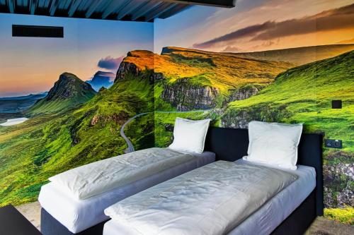 two beds in a room with a painting on the wall at SINATRA CIGAR HOUSE in Banská Bystrica
