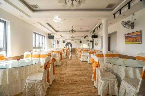 a banquet hall with tables and chairs in a room at BinBin Phúc Dalat Hotel in Da Lat