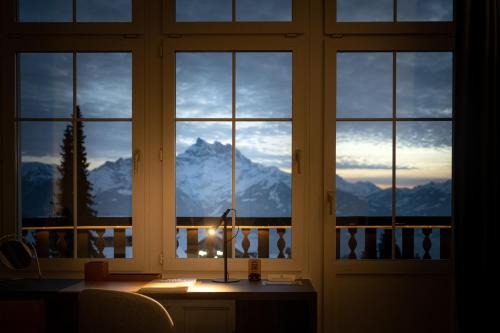 a window with a view of a mountain at Villars Palace in Villars-sur-Ollon