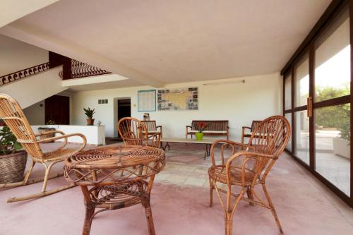 a living room with a table and chairs at Case Bongiovi in Sciacca