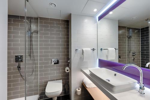 a bathroom with a sink and a shower at Premier Inn Berlin City Wilmersdorf in Berlin