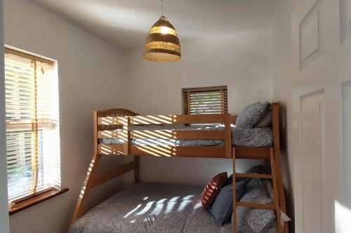 a bunk bed in a room with a lamp at The Stables in Skibbereen
