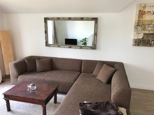 a living room with a couch and a mirror at FewoSchmiede1 in Grömitz