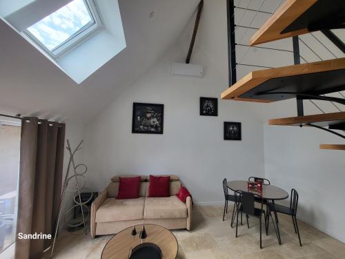 a living room with a couch and a table at Le gîte Chez Lucie in Le Liège