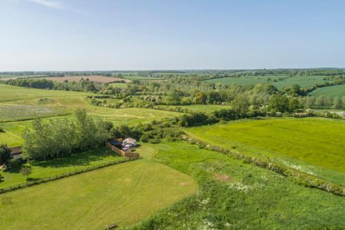 an aerial view of a field with a house at Luxury glamping in Constable Country - Valley View Yurt 