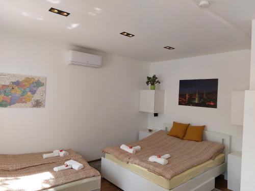 a bedroom with two beds in a room at R59 Apartman with free parking in Pécs