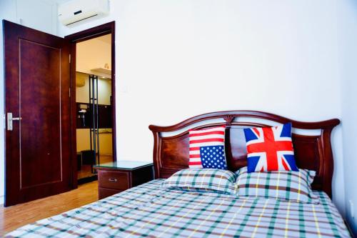 a bedroom with a bed with an american flag on it at Homestay Times City 04T1N in Hanoi