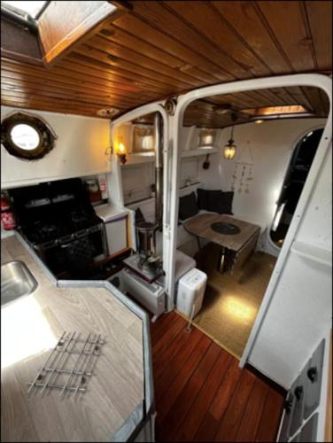 a view of the inside of an rv with a table at Bateau Watson, vivez l'aventure in Ouistreham