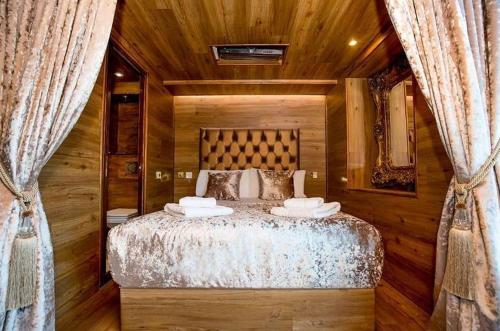 a bedroom with a large bed with wooden walls at The Shankly Hotel in Liverpool