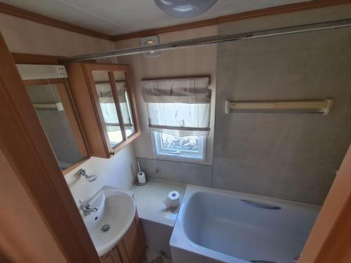 a bathroom with a sink and a toilet and a mirror at Rockley Park, Gorse Hill 38 in Lytchett Minster