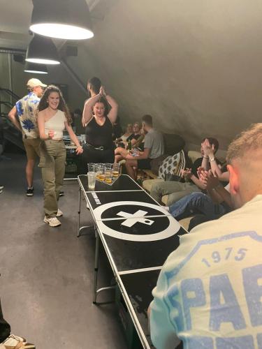 a group of people standing around a table in a room at Main Square Hostel in Zagreb