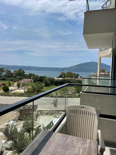 a balcony with a table and a view of the ocean at Jurgen's Apartaments in Vlorë
