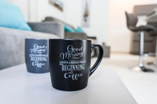 two coffee mugs sitting on a table at Zeituna Lodge a Porto Cesareo in Torre Lapillo