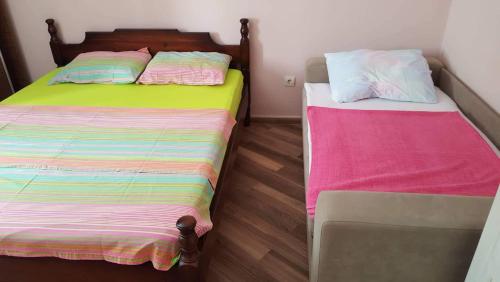 two beds sitting next to each other in a room at Apartman Jasovic in Risan
