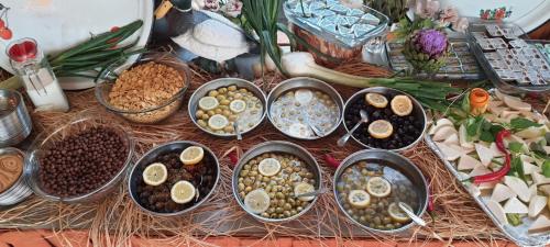 a bunch of bowls of food on a table at Grand Yayla Hotel in Cesme